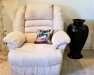 Off white soft leather recliner. Great tall black vase.