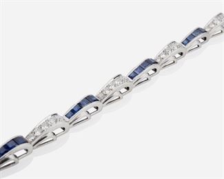 1007
An Art Deco Tiffany & Co. Sapphire And Diamond Bracelet
Circa 1920, platinum; Stamped: Tiffany & Co.
Set with thirty-five full-cut round diamonds totaling approximately 2.45ct, and graded F-G color and VS clarity, further set with thirty-five baguette-cut sapphires totaling approximately 4.2ct
7" L
20.9 grams
Estimate: $3,000 - $5,000