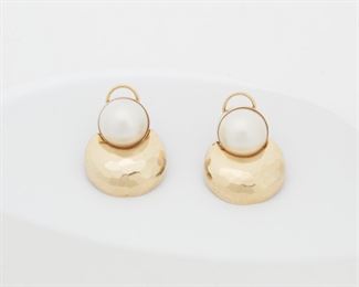 2030
A Pair Of Mabe Pearl Earrings
14k yellow gold
Each set with a mabe pearl measuring 15mm within a hammered gold framework
1.1" H x 1" W
21.7 grams
Estimate: $500 - $700