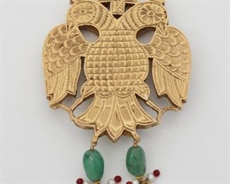 2057
An Indian Gem-Set Double-Headed Eagle Pendant
Tests 18k yellow gold
Topped with y tablet-cut emeralds and rubies suspending a two emerald beads measuring 4mm x 9mm seed pearls and ruby beads, the reverse bearing chased gold floral motif
3 x 1.25"
33.3 grams
Estimate: $1,000 - $1,500