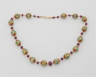 2059
A Ruby And Turquoise Bead Necklace
Tests 18k yellow gold
Suspending Indian inlaid turquoise and ruby beads measuring 12mm, alternating with graduated ruby beads measuring from 5mm-10mm
18" L
68 grams
Estimate: $1,500 - $2,000