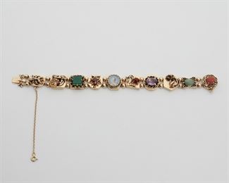 2069
A Gold And Gem-Set Slide Bracelet
14k yellow gold
Comprising ten various slides set with various gemstones including citrine, chrysoprase, garnets, amethyst, seed pearl, turquoise, and coral and a portrait miniature
7" L
35.8 grams
Estimate: $1,500 - $2,000