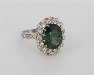 2078
A Green Tourmaline And Diamond Ring
14 & 18k white gold
Centering an oval-cut green tourmaline weighing 5.86ct and surrounded by twenty-eight full-cut round diamonds totaling approximately 0.85ct and graded J-K color and SI clarity
Ring size: 6.75
9.2 grams
Estimate: $1,000 - $1,500