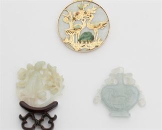 2123
Three Jadeite Items
Comprising a 14k yellow gold gem-set crane pendant set with ruby eyes and two carved jade desk ornaments (one with a wooden base)
Pendant: 2.5" L x 2.1" W
89 grams gross
3 pieces
Estimate: $600 - $800