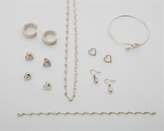 2133
A Group Of Tiffany & Co. Sterling Silver And Gold Jewelry
Sterling Silver and 18k yellow gold; Various stamps include: Tiffany & Co. / Mexico / 925 / 750 / T & Co. / Paloma Picasso
Comprising a Paloma Picasso necklace (16" L), bracelet (7" L) and earring suite, a heart bangle (6.5" C), three pair of heart shaped earrings, and a pair of woven hoop style earrings (.875" D x .375" W)
62.5 grams
13 pieces
Estimate: $400 - $600