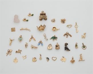 2152
A Group Of Charms
Comprising various 14k yellow gold, gemstone, costume, and silver charms consisting of a lantern, carousel, heart, sand dollar, slippers, purses, musical instruments, monkeys, pigs, and other miscellaneous charms
70 grams gross
38 pieces
Estimate: $1,500 - $2,000