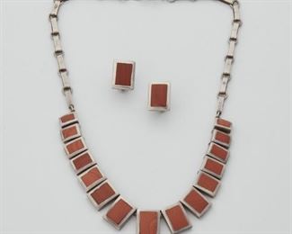 2168
A Group Of Piedra Y Plata Carnelian Jewelry
Third-quarter 20th Century
Stamped: Piedra Y Plata; Eagle 3; Further stamped: Martinez / Sterling / Taxco / 142
Comprising a necklace with 15 graduated carnelian set panels and matching rectangular earrings, 3 pieces total
Necklace: 15" L; Earrings: .5" L x .75" W
46 grams gross
Estimate: $500 - $700
