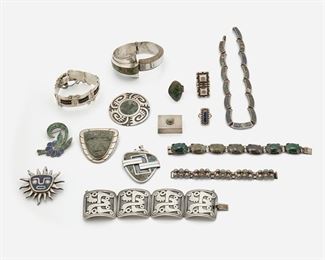 2186
A Group Of Mexican Silver Jewelry
Mid-20th Century; Taxco, Mexico
Variously marked
Comprising a sun-form pendant brooch, Miguel Melendez; a round overlay brooch, Cheo; a stone set mask brooch, Mexico; a stone set hinged bangle, E. Brito; a stone set linked necklace, Taxco/ 980; a seven-stone linked bracelet, SNC; a double sided pendant, by Victor Jaimez for Emma Melendez; a panel bracelet, Reveri, a four panel bracelet, Pedro Castillo; three rings, a child sized caviar bracelet; a stone set floral brooch, a hinged pill box, 15 piecs
Largest bracelet: 6.75" L x 1.75" W; Mask brooch: 2.25" L x 2" W
526 grams gross
Estimate: $500 - $700
