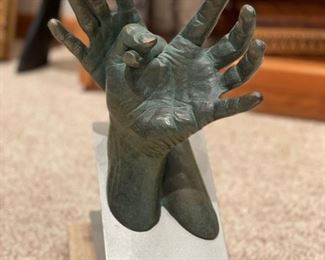 Bronze sculpt of hands.