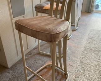 Set of four vintage upholstered metal bar stools.