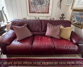 Vintage Roche Bobois red leather three seat sofa. Circa 1990s. Two available. Each measures 85"W x 39"D x 26"H.  Photo 2 of 3