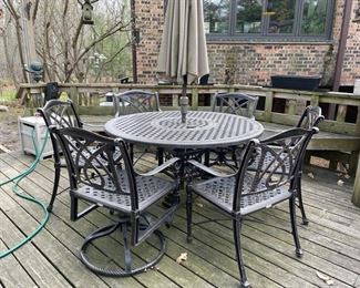 48" Round GenSun Grande Terrace outdoor table. Set includes two swivel rockers, four arm chairs and umbrella. Photo 1 of 3