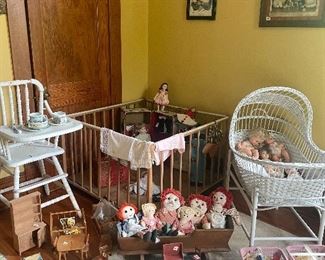 Old Raggedy Ann dolls and other antique dolls and accessories, wicker bassinet