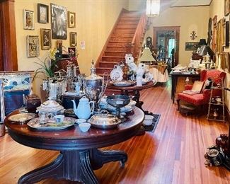 The front hall is jam packed with beautiful things including three antique tables, several pieces of Mulberry and tons of paintings. 