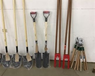 Unused shovels, post hole diggers and lopper shears. 