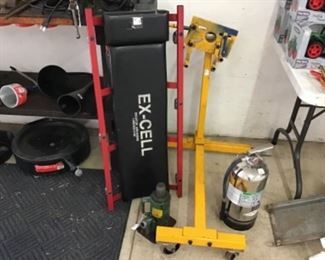 Pre-Owned Engine Stand, Stainless Steel Fire Extinguisher and a Mechanic's Creeper