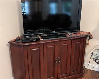 Awesome corner cabinet/TV stand.  Nice Toshiba flat screen