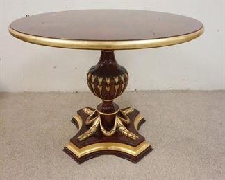 1004	MAHOGANY TABLE ON URN SHAPED PEDESTAL HAS CARVED SWAG W/ GILT ACCENTS. 40 IN X 30 IN 
