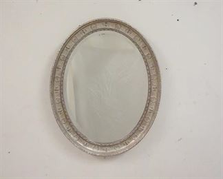 1018	BEVELED GLASS MIRROR IN GILT & EMBOSSED SILVER FRAME. 22 IN X 28 IN. 
