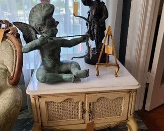 49.) Vintage Marble top end table with a pair of bay doors. 25"x 25"x 22".  Bronze figure with bow and arrow, and a bronze cast Renaissance male figure there is a foundry cast mark. 
