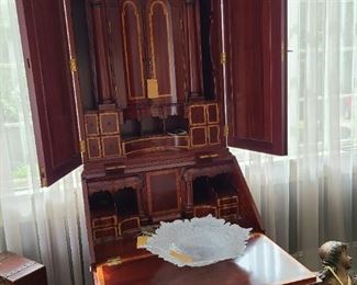 13.) Indonesian cabinet work in the manner of a Asian/Chippendale style. extensive use of banding and mahogany.  The use of multiple cache drawers, cubby holes open folios and theatrical interior. 7'h x 22"d x 30"w. Note agate glass blown Art-glass bowl.