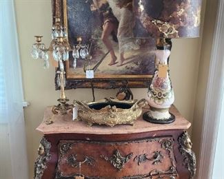 8.) Bombe chest of two wide drawers, heavy use of applied ormolu over marquetry woods of walnut and mahogany. The pink marble top rest on frame. 38"w X 19"d X 35"h.