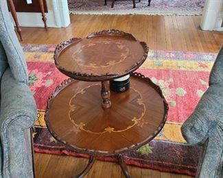 72.) Two Tier round table with inlayed service. Circa 1950.