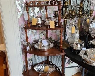 87.) Walnut "What Not" corner shelf circa 1850s, set with a collection of silver plate serving pieces. 