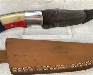 Mfg - Custom Hand Made
Model - Damascus Steel Knife
Caliber - 4.25" Blade
Located in Chattanooga, TN
This lot contains a Custom hand made Damascus steel fixed blade, full tang knife. 4.25" Blade, overall lenth 8.5". Comes with custom embossed leather sheath.