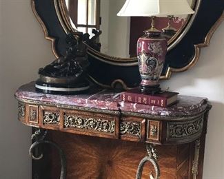 Stunning French gilt bronze mounted ormolu entry table.
Large black and gold decorator mirror.