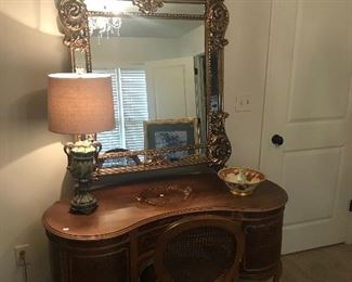 French Provencial dressing table or desk.  Louis Philippe caned chair and large polyform mirror in gloss gold.