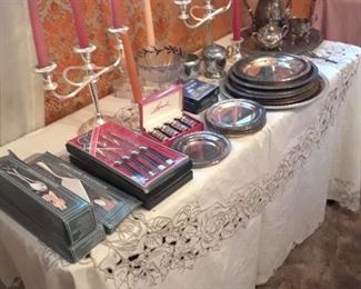 Silverplated candlesticks, bread and butter plates, and trays