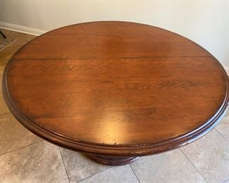 Lot#18  $750.00  54" round pedestal dining table           has one 20" leaf