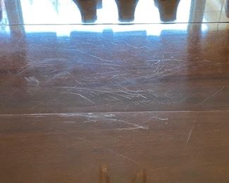 fine marks on table visible under raked light