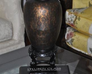 Leopard D'Oro Design Jar with Floral Finial, 22" x 13". shown with an oversize book, "Steuben Glass" by Mary Jean Madigan