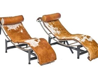 Pair of Mid-Century lounge chairs, speckled brown and white cowhide, leather headrests, on metal base.
20"h x 55"w x 21"d/ each