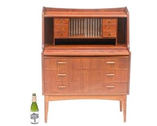 Danish Mid-Century secretary desk, six drawers flank open shelves and two sliding glass doors, extendable writing surface, above three drawers, rising on pin legs.
42"h x 33.5"w x 17.5"d