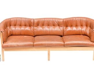 Danish Mid-Century sofa, three seat, brown leather, bent wood back, rising on wooden frame.
32"h x 86"w x 34"d