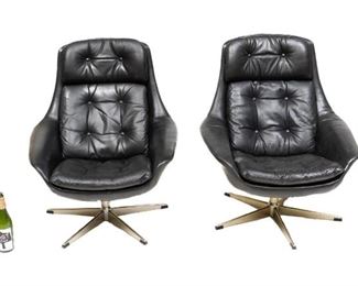 Pair of Danish Mid-Century arm chairs, black leather, button back, chrome swivel base.
35"h x 30"w x 29"d/ each