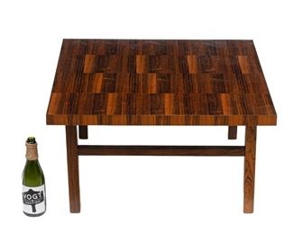 Danish Mid-Century side table, patchwork motif, rising on stretchered straight legs.
17"h x 31.5"w
