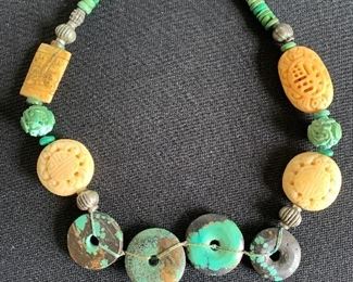 Artist made necklace featuring turquoise discs 