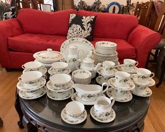 Royal Doulton Larchmont porcelain dinnerware with red suede sofa in background 