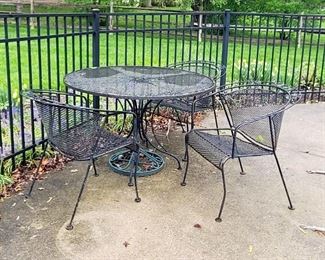 Metal outdoor table with chairs and umbrella stand 