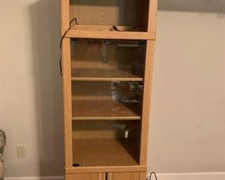 #9	entertainment center in 3 pieces (2) shelves with door and a bridge on top 21x16x71 each shelf 	 $75.00 
