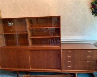 #10	Mid-Century Danish teak cabinet that can be made in to 3 pieces. Shown with long support piece on the bottom making it 88 inches long then with the extra legs and smaller support for each cabinet 59Wx18Dx30H  (2 of these) plus 4 Drawer Chest  29Wx18Dx30H 	 $1,200.00 
