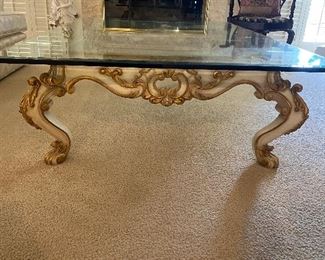 Coffee table, carved wooden base, painted cream color and gold gilt. Bevelled glass top measures approx 4' x 6'  and is approx 5/8" thick...Approx 18" off ground. $495 No calls/email only please. 