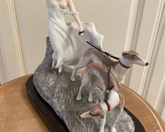Icart Porcelain Figurine. Wooden base. Leather leash broken. "Coup de Vent" Measures approx 8 1/2" tall and 9" long $150  No calls/email only please. 