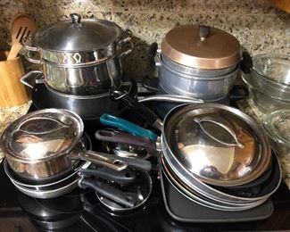 Kitchen full, including a large assortment of cookware -- numerous pots and pans shown here.