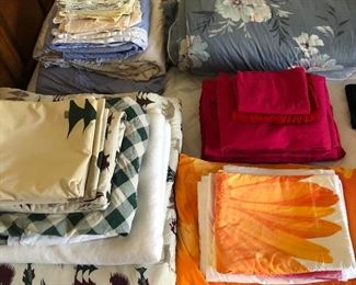 Assorted bedding and linens.