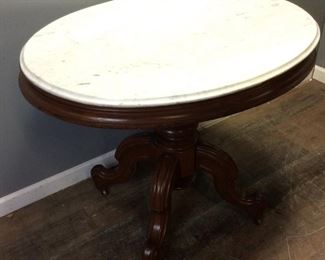 VTG. MARBLE TOP OVAL TABLE ON WHEELS
